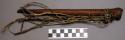 Whistle, tubular piece of wood, strips of monkey fur tied on end (nsangu)