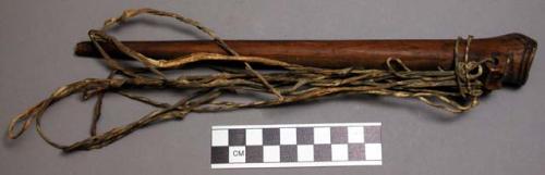 Whistle, tubular piece of wood, strips of monkey fur tied on end (nsangu)