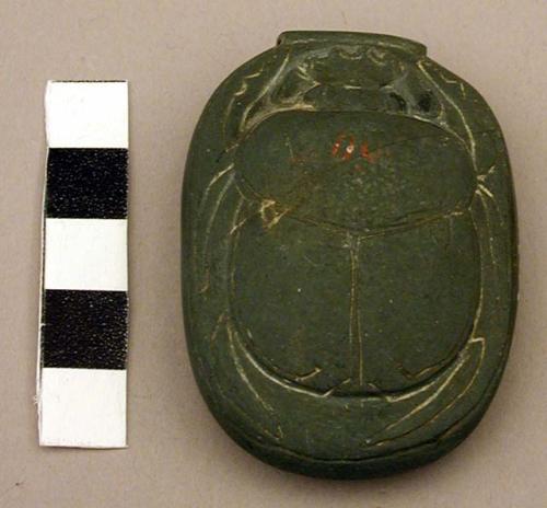 Stone scarab, incised hieroglyphics on bottom