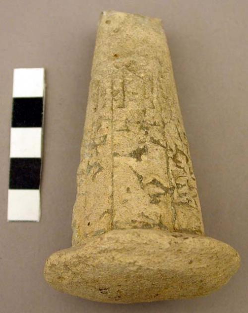 Cone shaped plaster with larger circular base and wedge shaped incisions