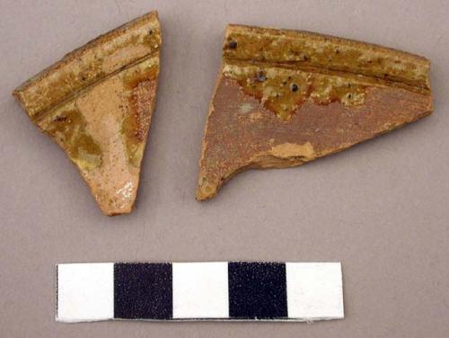 Ceramic rim sherd, redware, groove parallel to rim, areas of glaze