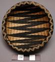 Basket, rounded body, lipped rim, woven dark & natural zig-zag designs