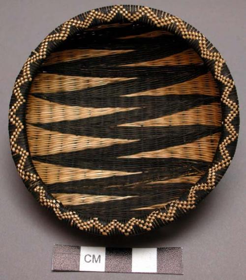 Basket, rounded body, lipped rim, woven dark & natural zig-zag designs