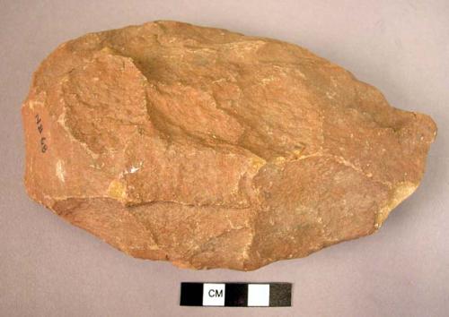 Large-sized quartzite hand axe roughly oval in form, well trimmed butt, with poi