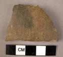Ceramic body sherd, brown slippe exterior, black slipped interior, micaceaous