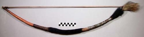 Bow, carved wood, covered with skin and metal wraps, fur decoration and grip