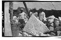 Caracol. Laborers grouped around block from 5-member cornice