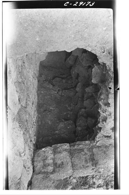 Caracol, pit at S. side lower stairway against the lower terrace.