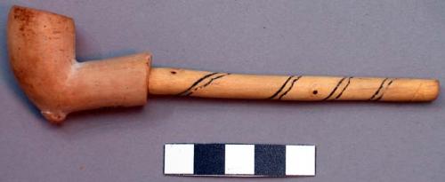 Stone pipe with spiral decoration burned on wooden stem. Also M J on one side.