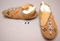 Pair of skin moccasins with beadwork trimming