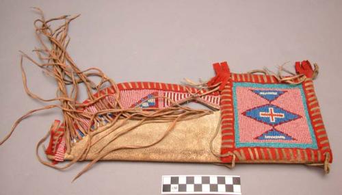 Blackfoot knife sheath. Spotstitch beadwork, cloth trim, and fringe