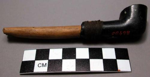 Small woman's stone pipe and stem of black soapstone.