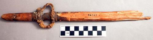 Broken wooden dagger-like object. Catalog: “grip ends of atlatls, 3”.