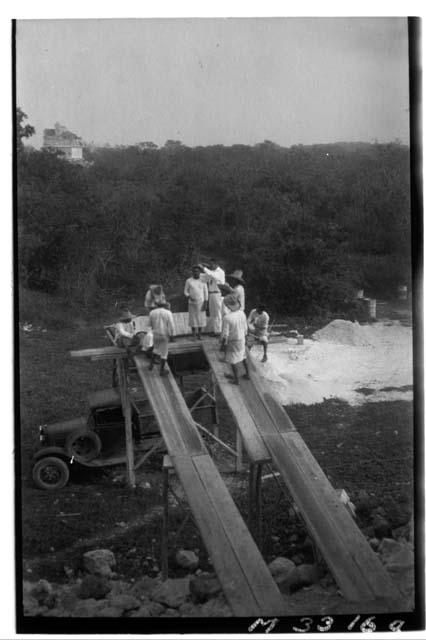 Dr. Morris Steggerda measuring workmen on dump hopper at Monjas