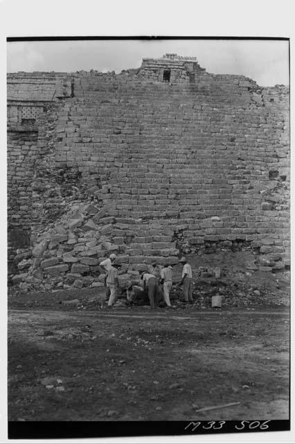 Men unearthing Chac Mool at base of Main Stairs at Monjas