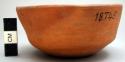Ceramic bowl, flat base, straight walls, orange w/blk smudge on int.