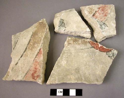 Fragments of the plaster wall of a ruined lamasery, painted