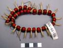 Two strand brownish orange bead necklace, bone carved claws, +