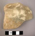 Undecorated buff potsherd with folded ledge handle