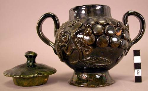 Black glazed footed, handled, lidded jar