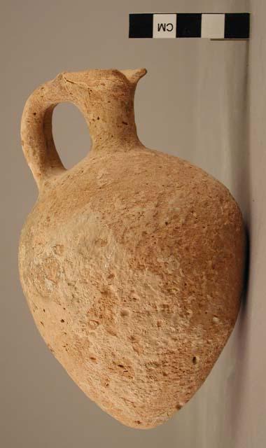 Broad pottery  juglet - 2-strap handle; pointed base;