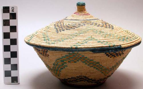 Small basket, coiled weave, pattern in blue, green, orange; stripes of cerise &