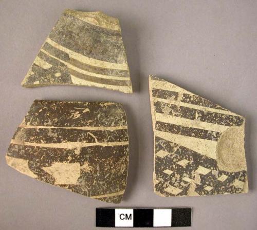 Ceramic rim and body sherds, white ware with black painted geometric design