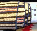 Banded blanket, white stripes alternating with brown and black stripes