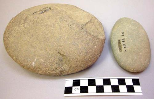 Ground stone objects, 1 round flat worn, 1 ovate flat worn