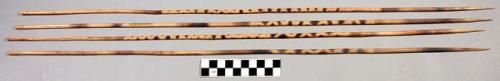 Wooden arrows, charred design on shafts, nseko