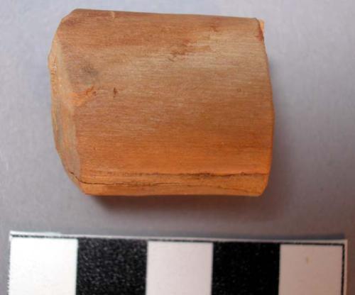 Small wooden block cut at one end