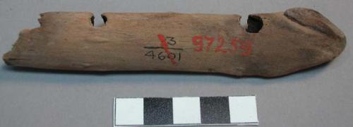 Wood fragment split lengthwise with four partially bored holes, broken at end