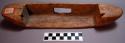 Wood object, carved, ovate w/rectangular cutout, rectangular hole, 2 indents at