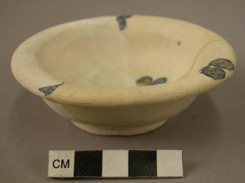 Glazed clay bowl with blue designs