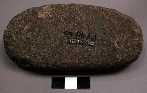 Ground stone object, ovate, flat side, ends pitted--possibly used for pounding?