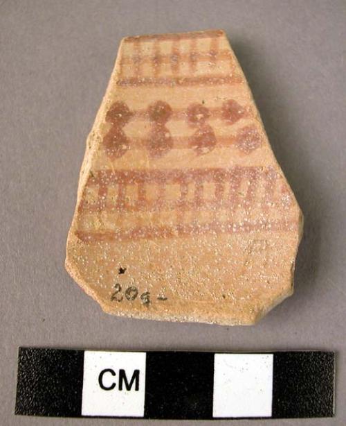 Ceramic rim sherd, chalky buff ware w. red painted geometric design