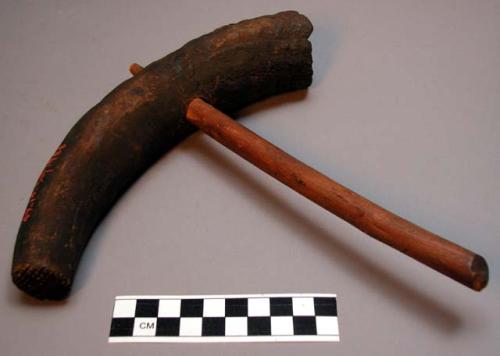 Hammer of wood and cow horn for bark cloth.  Mwango