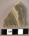 Grey body sherd, fine paste, both surfaces burnished, exterior decorated by a ri