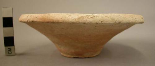 Pottery dish; flaring sides; reddish- beige.