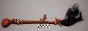 War club. Stone head, wood handle, red painted leather with fringe. Ornamented