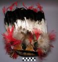Chief's bonnet of buckskin with pinked and beaded band. Set with 36 golden eagle feathers.