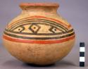 Pottery jar, yellow with red and black on upper zone