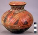 Pottery jar, red with black ornamentation on upper zone which is divided by