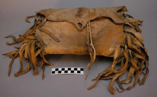 Crow medicine bag of hide. Fur on exterior. Wide hide fringe and fur down sides