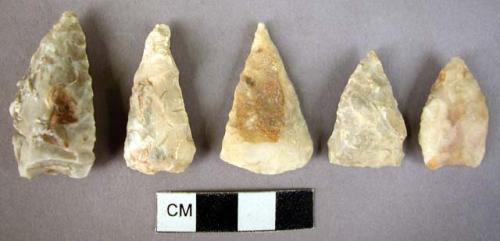 5 roughly worked triangular flint arrowheads