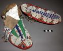 Pair of Sioux fully beaded moccasins. Soft soles. Mostly white background
