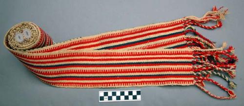 Woven wool belt, red and blue stripes on white background. 10 x 228 cm. minus b