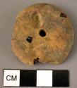 Fragmentary large disk-shaped amber pendant, double drilled