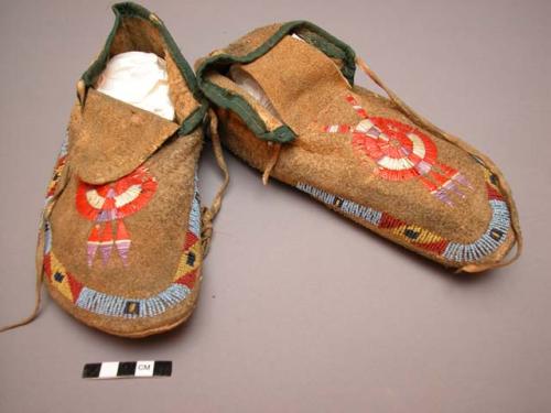 Pair of Sioux moccasins. Hard soles w/ leather uppers. Triangular tongue sewn on