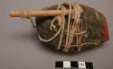 Sack and oval object covered with string and smeared with egg - used by Zo to "t